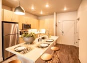 Thumbnail 9 of 44 - Kitchen With Island Dining at Soleil Lofts Apartments, Herriman, UT