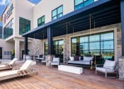 Thumbnail 30 of 44 - Poolside Relaxing Lounge Area at Soleil Lofts Apartments, Herriman