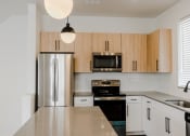 Thumbnail 5 of 37 - Modern Kitchen with Stainless Steel Appliances at The Hudson Townhomes Salt Lake City Utah 84106