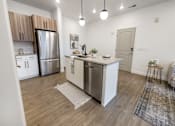 Thumbnail 21 of 54 - A modern kitchen with wooden cabinets and a white island.
