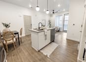 Thumbnail 22 of 54 - A kitchen with a white cabinet and a grey fridge.