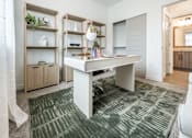 Thumbnail 17 of 54 - A white desk with a lamp and a green rug in front of it.