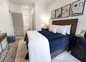 Thumbnail 12 of 54 - A bedroom with a large bed and a painting on the wall.