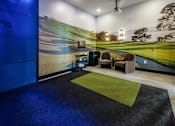 Thumbnail 30 of 54 - A room with a golf course mural on the wall and a green carpet.