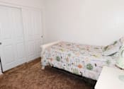 Thumbnail 9 of 20 - Secondary Bedroom with Double Closet Doors at River Oaks Apartments & Townhomes, Hanford, CA