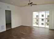Thumbnail 3 of 16 - Open Living Area with Woodgrain Flooring at Kimpton Square Senior Apartments, Midvale, UT 84045