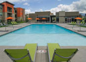 Thumbnail 2 of 40 - Umbrella Shaded Chairs By Pool at Lofts at 7800 Apartments, Midvale, UT, 84047