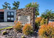 Thumbnail 42 of 46 - A stone sign that says "Aquinas College" is in front of a building.