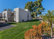 Thumbnail 40 of 46 - A modern house with a white exterior and a green lawn in front.