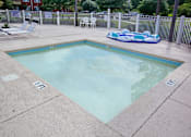 Thumbnail 12 of 18 - A small pool with a blue inflatable in the middle. Aviary Village Apartments, in Conway, SC 29526