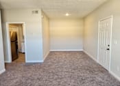 Thumbnail 6 of 10 - A room with a carpeted floor and a white door. The Cloisters Apartments, 902 67th Avenue North, Myrtle Beach, SC