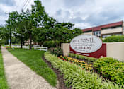 Thumbnail 3 of 14 - A sign for River Pointe Apartment Homes is displayed in front of a building.