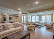 Thumbnail 12 of 17 - A living room with a couch, chairs, and a coffee table.