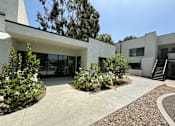 Thumbnail 15 of 44 - the exterior of the community room with a courtyard in front of it