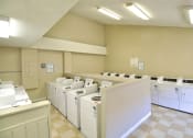Thumbnail 30 of 30 - a group of washers and dryers in a laundry room at Brookhollow Apartments, California, 91792