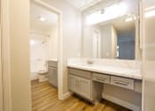 Thumbnail 11 of 30 - a bathroom with a large mirror and a sink and a toilet