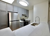 Thumbnail 2 of 30 - a kitchen with a sink and a refrigerator