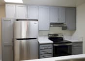 Thumbnail 8 of 30 - a kitchen with stainless steel appliances and white counter tops
