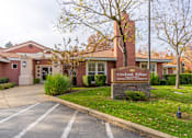 Thumbnail 1 of 13 - The image shows the front of a building named Creekside Village.