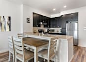 Thumbnail 13 of 21 - a kitchen and dining room with a table and chairs