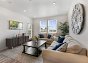 Thumbnail 16 of 21 - a living room with a couch and a table