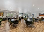 Thumbnail 9 of 21 - a large dining room with tables and chairs