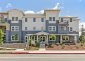 Thumbnail 2 of 21 - a large apartment building on the side of a street