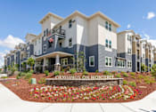 Thumbnail 1 of 21 - a crossroads on montgomery apartment building with a flower garden in front of it