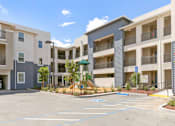 Thumbnail 18 of 21 - an empty parking lot in front of an apartment building