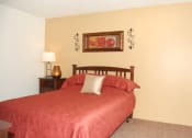 Thumbnail 9 of 12 - a bedroom with a bed and bedside table