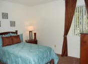 Thumbnail 10 of 12 - a bedroom with a bed and a window with curtains