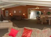 Thumbnail 4 of 12 - a community room with a couch and a dining room