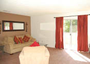 Thumbnail 8 of 12 - a living room with a couch and a sliding glass door