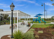 Thumbnail 2 of 12 - a playground and pavilion in a park with a blue slide