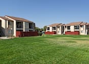 Thumbnail 5 of 7 - a row of houses on a green lawn