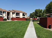 Thumbnail 4 of 7 - a sidewalk in front of a row of houses