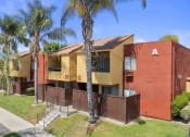 Thumbnail 26 of 30 - a yellow and red apartment building with palm treesat Brookhollow Apartments, West Covina , CA