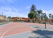 Thumbnail 28 of 30 - a basketball court in a park with apartments in the backgroundat Brookhollow Apartments, West Covina , CA 91792