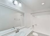 Thumbnail 17 of 30 - a bathroom with a mirror and a sink and a shower at Brookhollow Apartments, California