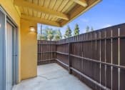 Thumbnail 23 of 30 - the patio has a wood fence and a glass door at Brookhollow Apartments, West Covina , California