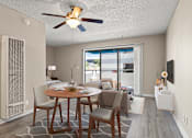 Thumbnail 24 of 38 - A dining room with a table set for two and a ceiling fan in a studio apartment at Harbor Terrace Apartments, California, 90731