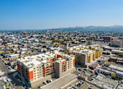 Thumbnail 3 of 17 - A cityscape with buildings and roads under a clear sky.