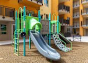 Thumbnail 16 of 17 - A playground with a green slide and a grey slide.