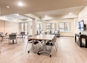 Thumbnail 7 of 17 - A conference room with a long table and chairs.