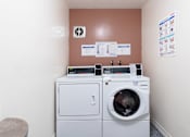 Thumbnail 10 of 16 - a laundry room with a washing machine and a dryer