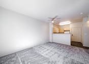 Thumbnail 17 of 20 - an empty living room with white walls and a ceiling fan
