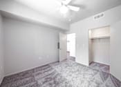 Thumbnail 19 of 20 - a bedroom with white walls and light grey carpet