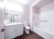 Thumbnail 20 of 20 - a bathroom with bath tub including handle bar, toilet, and sink