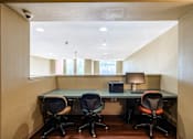Thumbnail 13 of 20 - an office with a desk and chairs and a window