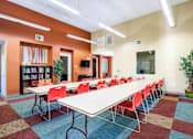 Thumbnail 12 of 20 - a large conference room with a long table and chairs
